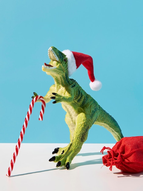 Free photo dinosaur toy with christmas candy