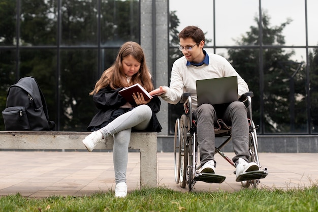 Free photo disabled man helping girl learn