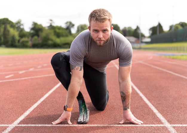 Disabled man on running track full shot