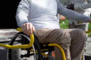 Free photo disabled man in wheelchair side view