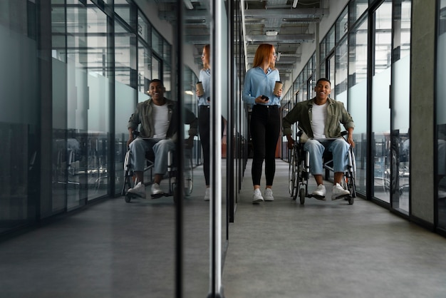 Free photo disabled man in a wheelchair working at his office job