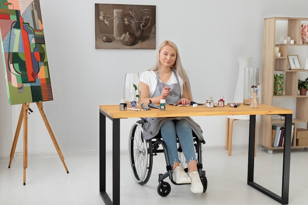 Free Photo disabled person in wheelchair painting