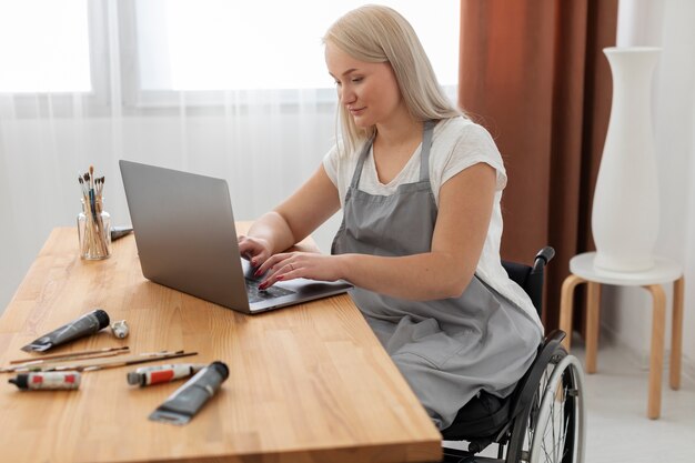 Disabled person in wheelchair working on laptop