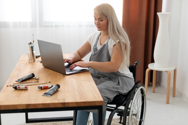 Disabled person in wheelchair working on laptop