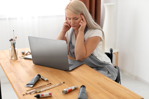 Disabled person in wheelchair working on laptop