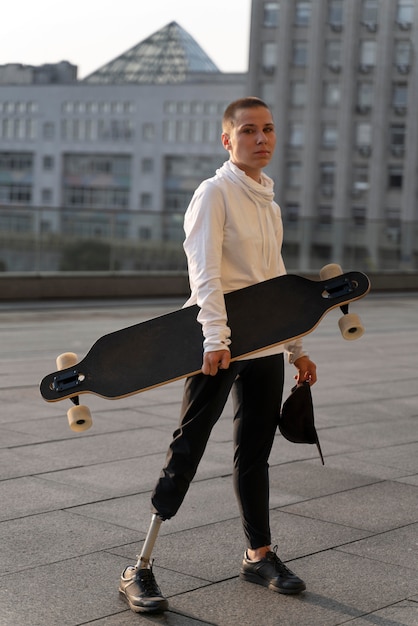 Disabled person with skateboard outdoors