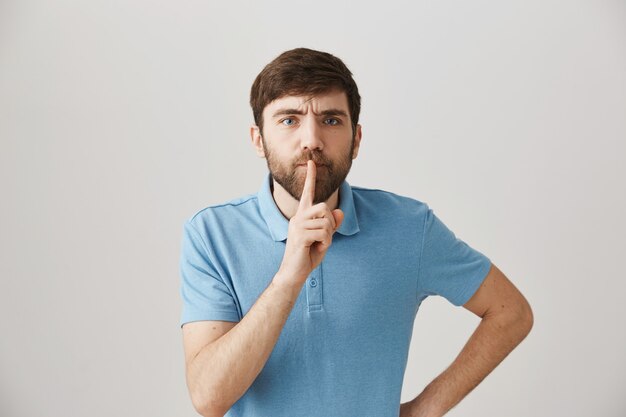 Disappointed young bearded man posing