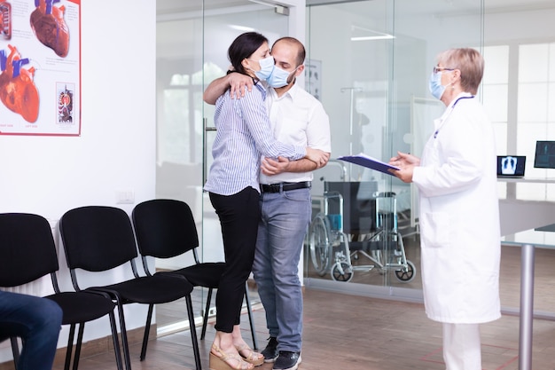 Free photo disappointed young couple in hospital waiting area from doctor unfavorable bad news during coronavirus outbreak