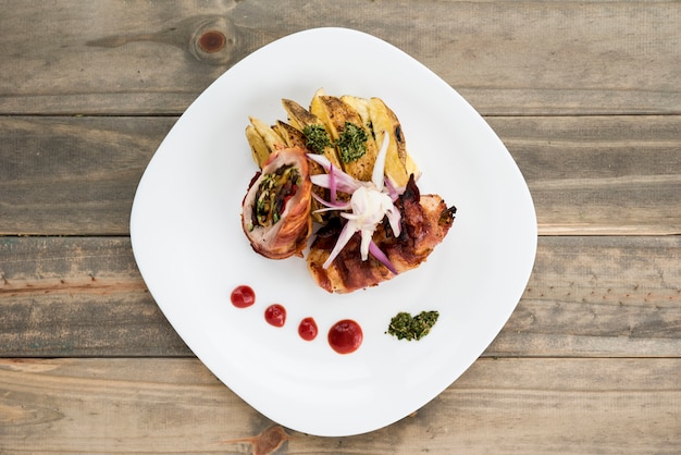 Free Photo dish with meat and potato on wooden desk