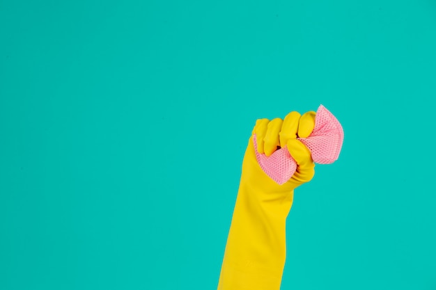 Free photo dishwasher wearing yellow gloves on a blue .