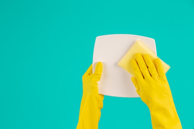 dishwasher wearing yellow gloves on a blue .