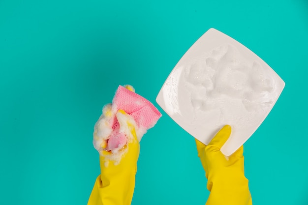 dishwasher wearing yellow gloves on a blue .