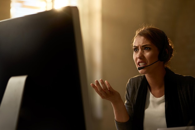 Free Photo displeased businesswoman reading problematic email on a computer in the office