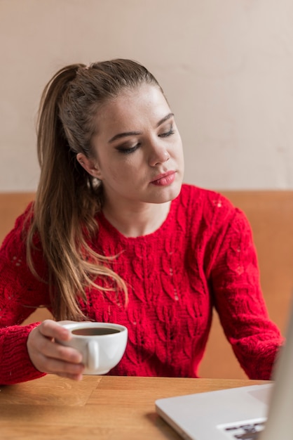 Distracted girl holding a cup of tea