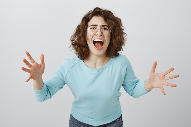 Free photo distressed and mad, heartbroken woman screaming and shaking hands, girl having argument, scolding someone