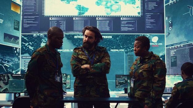 Diverse army officers examining real time data on a hologram