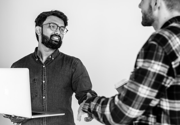 Free Photo diverse colleague men shaking hands together