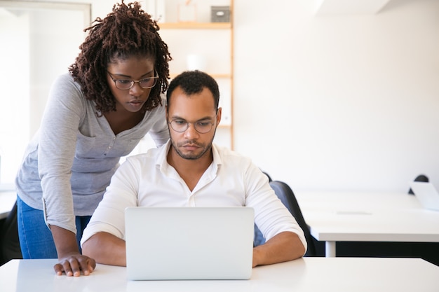 Diverse colleagues watching presentation on computer