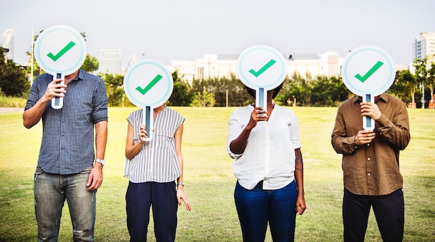 Free photo diverse friends holding checkmark icons