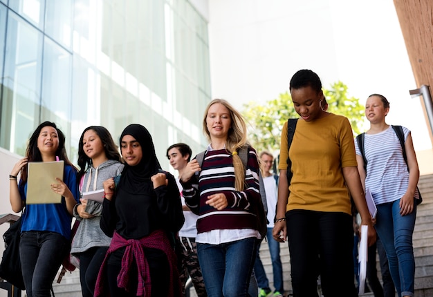 Free photo diverse group of students walking in school