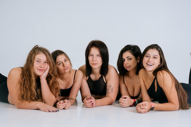 Free photo diverse models wearing comfortable underwear lie on the floor