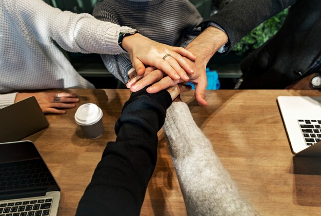 Diverse people stacking hands together