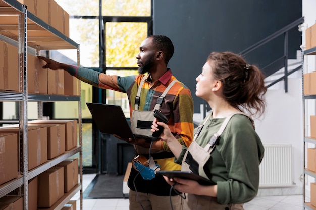 Free Photo diverse storehouse employees checking cardboard boxes