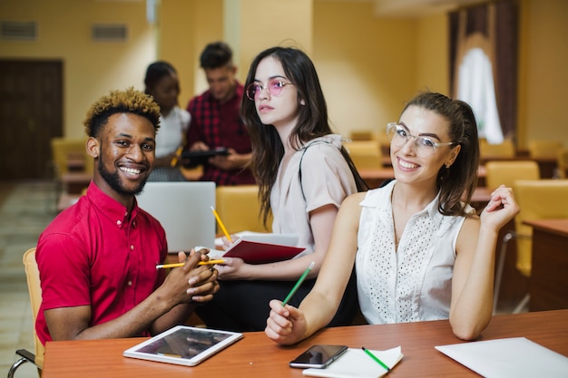 Free photo diverse students posing in classroom