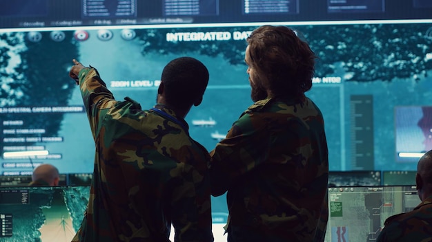 Diverse team of military personnel examining gathered information