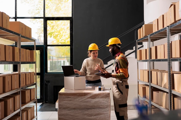 Diverse warehouse employee analyzing goods logistics