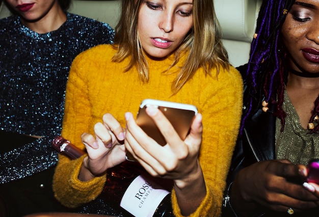 Free photo diverse women in a backseat of a cab