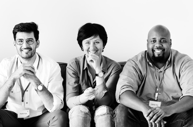 Diverse workers sitting together on couch