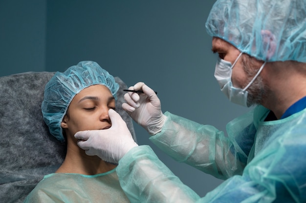 Free photo doctor checking patient before rhinoplasty side view