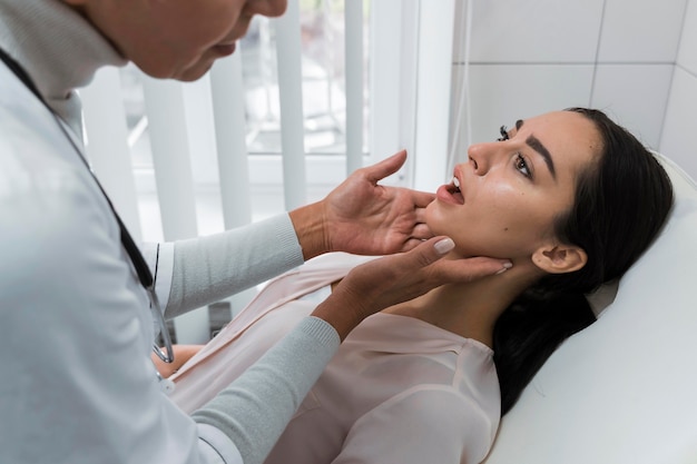 Doctor checking a patient's mouth