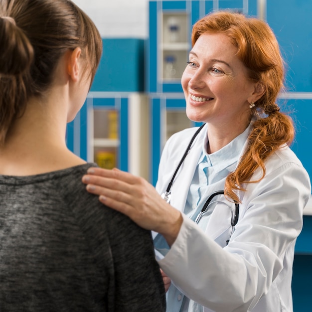 Doctor consulting patient and smiles