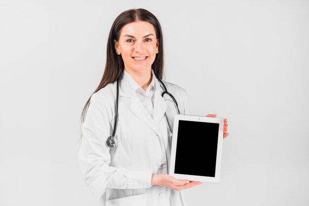 Doctor female smiling and showing tablet