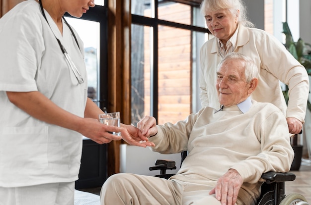 Doctor giving pills to her patient