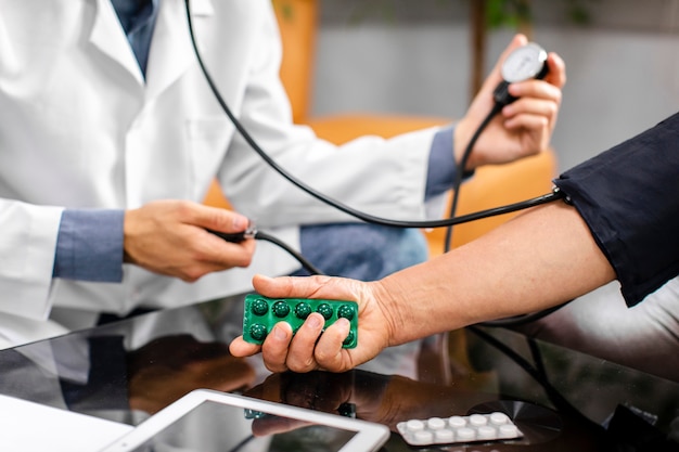 Free photo doctor hands carefully measuring tension