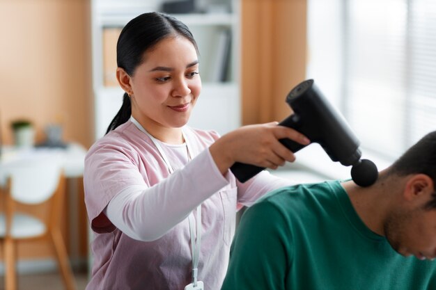 Doctor helping patient during rehabilitation