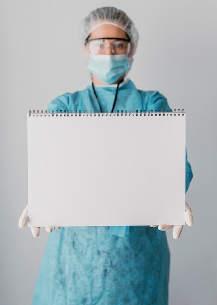 Doctor holding a blank card