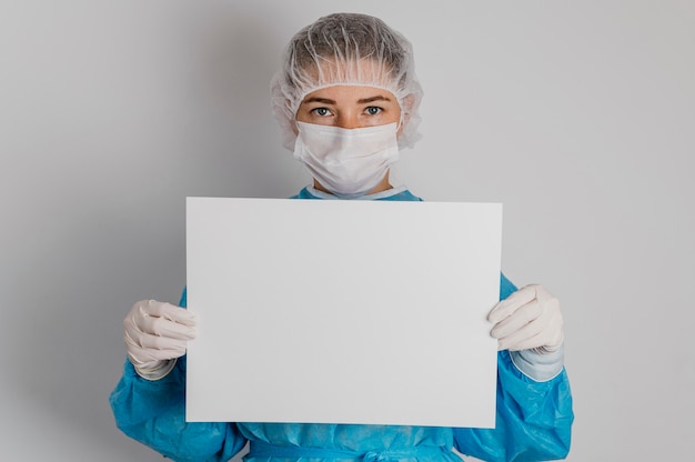 Free photo doctor holding a blank placard