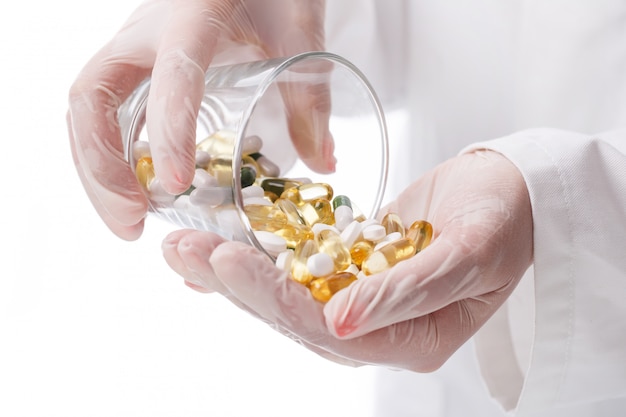 Doctor holding glass of pills