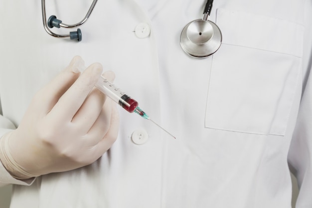 Free Photo doctor holding needle with blood