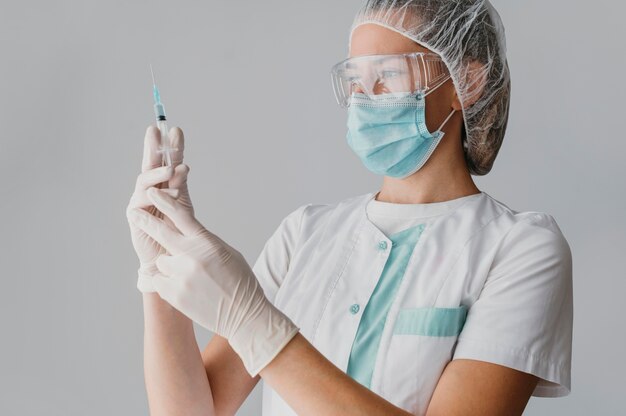 Doctor holding a syringe for a vaccine