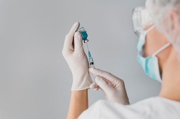 Doctor holding a syringe for a vaccine