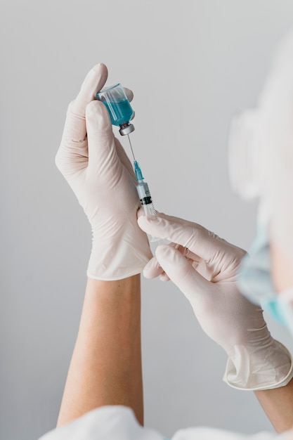 Doctor holding a syringe for a vaccine