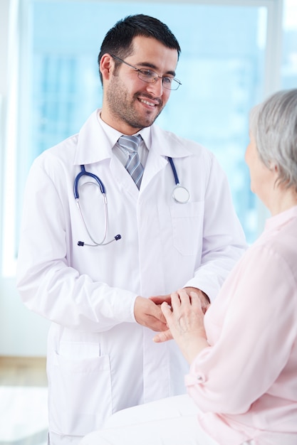 Doctor interacting with his elderly patient