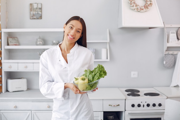 Doctor in a kitchen with vegetables