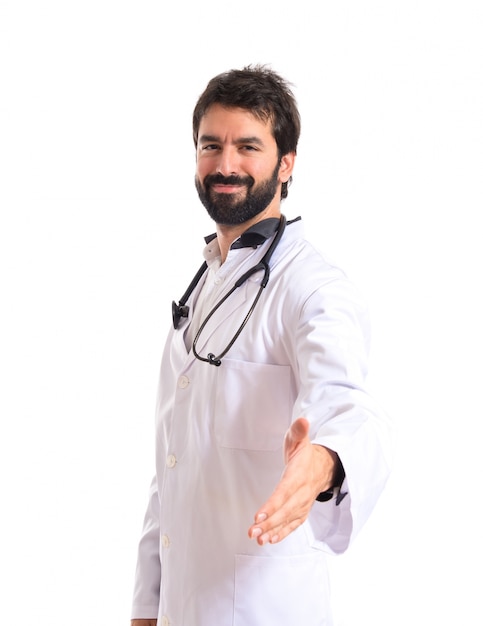 Doctor making a deal over isolated white background