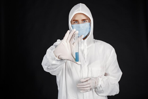 Doctor in a medical mask. Coronavirus theme. Isolated over white background. Woman in a protective suit.